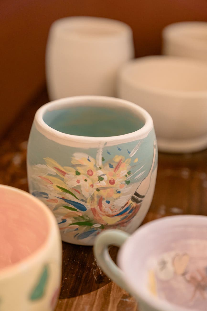 Colorful handmade pottery on display, showcasing artistic designs in a creative workshop setting.