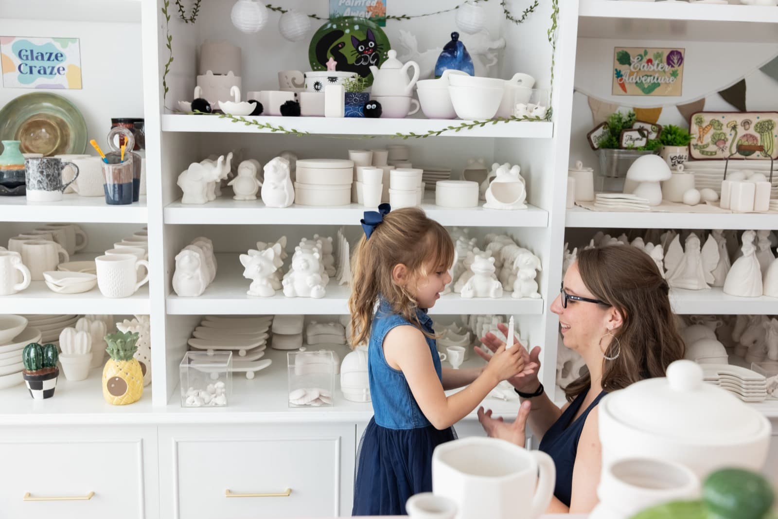 Customers choosing pottery to paint at the studio