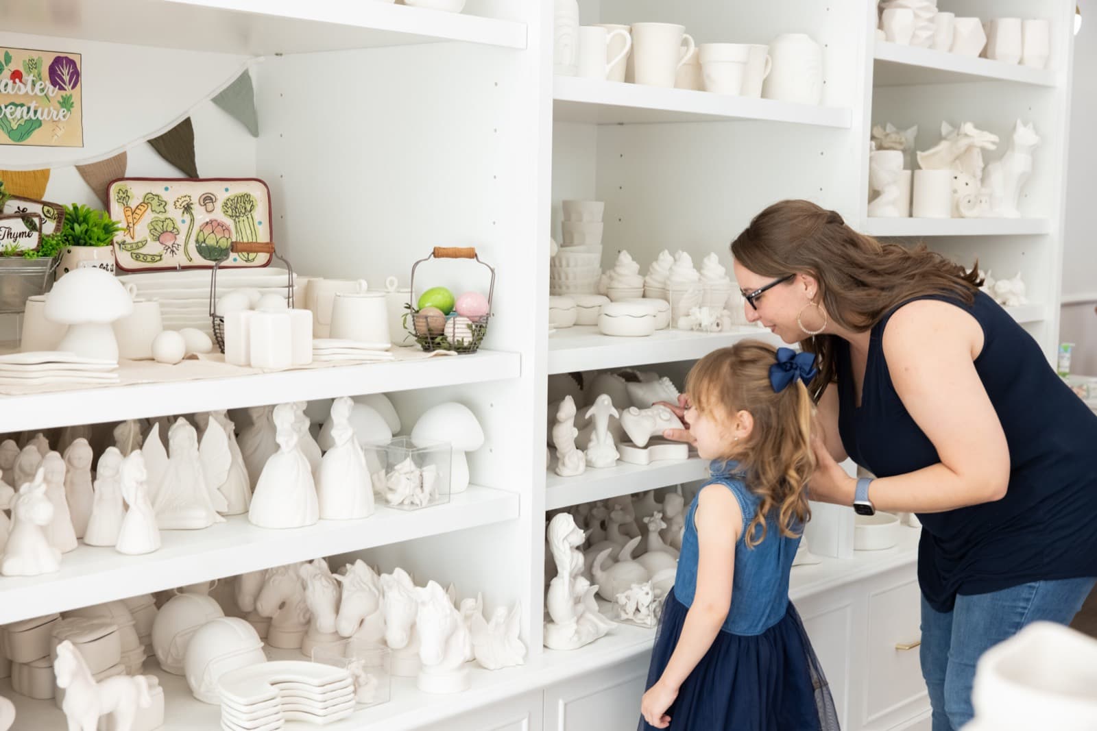 Customers choosing pottery to paint at the studio