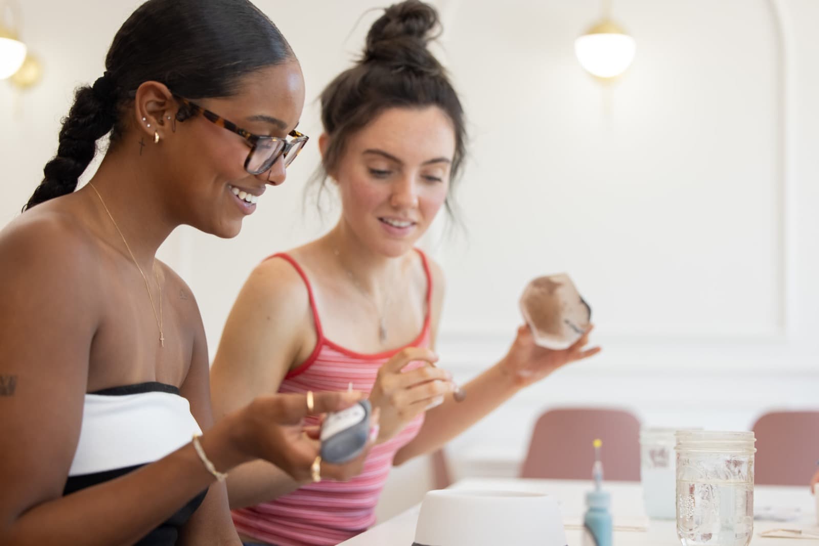 Young adults painting pottery together